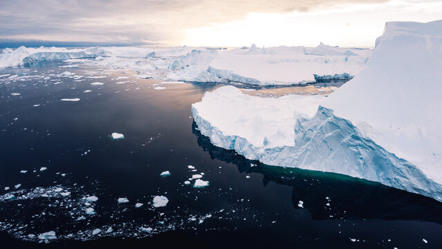 Aerial view of ilulissat icefiord in greenland with enourmous icebergs on sunny day