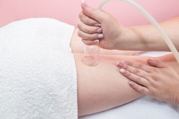 Hardware cosmetology. Vacuum massage procedure in a medical beauty center.