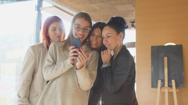 Girls having fun at a cafe bar. Female friends taking selfy photo.
