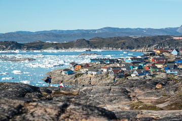 Aerial view of Ilulissat town during summer and sea full of icebergs in greenland