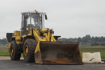 Big yellow bulldozer on the road