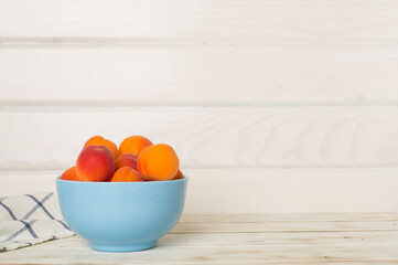 Composition with ripe apricots on wooden table