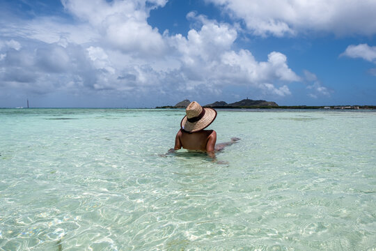 Madrinsky, Los Roques Archipelago, Venezuela: a young woman in the white beach with crystalline water.