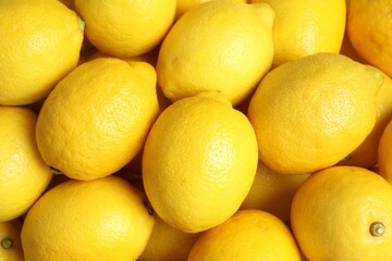 Many fresh ripe lemons as background, top view
