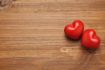 Red hearts on wooden background, flat lay with space for text. Happy Valentine's Day