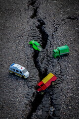 Colourful car toys on a cracked asphalt