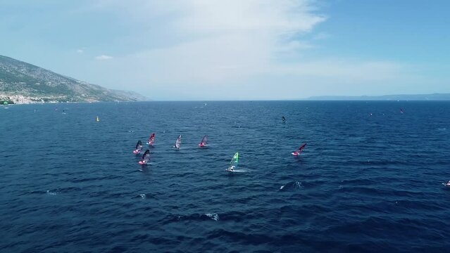 Bol, Croatia - 02 July 2022: Aerial view of windsurfers during the PWA world cup on beach on Zlatni Rat in Bol on the island of Brac, Croatia.