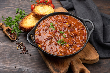 Bean and corn soup or ragout, red bean stew on a wooden background. Food Protein Vegan dish