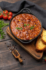 Bean and corn soup or ragout, red bean stew on a wooden background. Food Protein Vegan dish