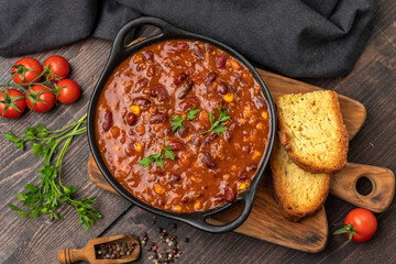 Bean and corn soup or ragout, red bean stew on a wooden background. Food Protein Vegan dish