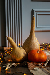 autumn background with three pumpkins on a plaid with garland. Halloween Mood.
fall atmocphere