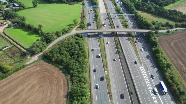Aerial View of British Motorways With Fast Moving Traffic at Peak Time. M1 J11 and  J7 Motorways Junction Interchange. Time Lapse Shot captured on 7th Sep 2022