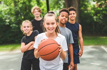 Fototapeten great child Team in sportswear playing basketball game © Louis-Photo