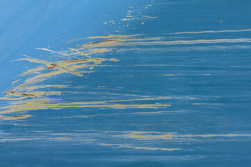Yellow scratches in blue lacquer layer