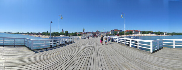 07.06.2022 - panoramic view of the old wooden white pier Molo on the coast of the Baltic Sea in Sopot. Pomeranian Voivodeship of Poland.