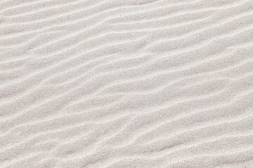 Fototapeta na wymiar wave shaped sand surface, natural pattern, sand surface, abstract background