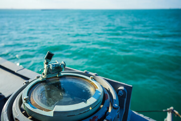 Compass on a military ship sailing on the sea
