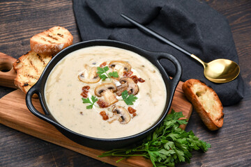Mushroom soup with bread and fresh mushrooms on a wooden background , autumn seasonal cream soup with vegetables 