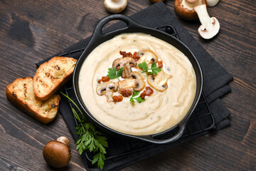Mushroom soup with bread and fresh mushrooms on a wooden background , autumn seasonal cream soup with vegetables  - obrazy, fototapety, plakaty