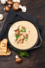 Mushroom soup with bread and fresh mushrooms on a wooden background , autumn seasonal cream soup with vegetables 