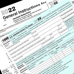 2022 IRS tax forms lay on a desk top.