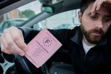 man gives his driver's license following a traffic violation
