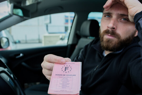 man gives his driver's license following a traffic violation