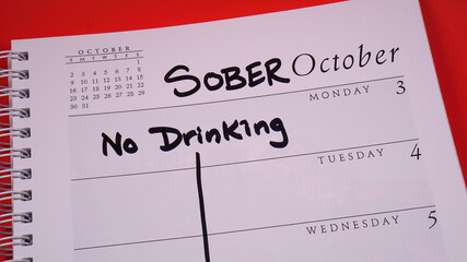 Sober October marked on a 2022 calendar. Sober October is the new and more poetic Dry January. It involves cutting out alcohol for 31 days, often for charity. - obrazy, fototapety, plakaty