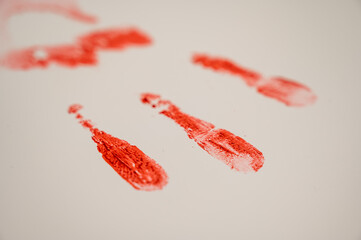 Hand prints in blood on a white table. 