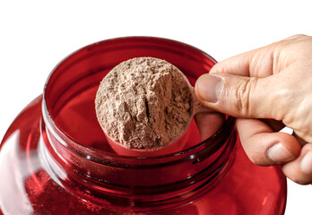 Had holding a scoop of whey protein.