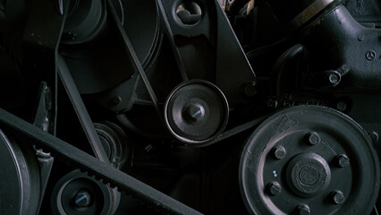 Timing belt with rollers installed on the old engine in a car workshop. photographed at close range
