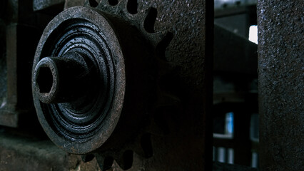 Rusty gears and pulley from old mechanism photographed at close range
