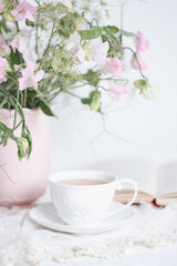 Fototapeta na wymiar White tea cup with flowers