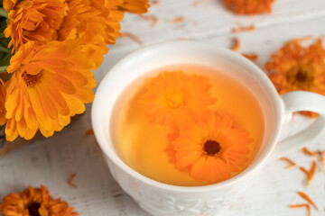 Calendula tea in a white cup