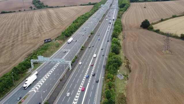 Aerial View of British Motorways With Fast Moving Traffic at Peak Time. M1 J11 and  J7 Motorways Junction Interchange. Time Lapse Shot captured on 7th Sep 2022