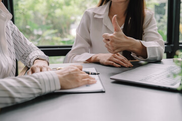 Marketer or analytic manager team dressed in suits working with paper charts and laptops at the meeting room.
