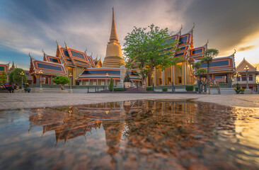 Fototapeta premium Picture of Wat Ratchabiton reflecting the water after the rain in Bangkok, Thailand, the moment after the sunset