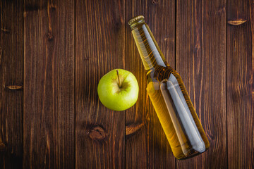 Apple cider in a bottle on a wooden table