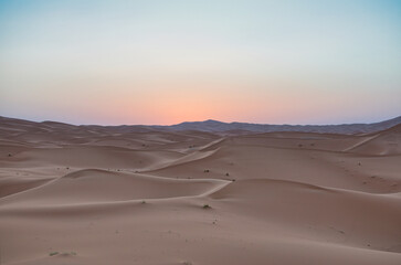 Obraz na płótnie Canvas Dunes in the Sahara desert at sunrise, the desert near the town of Merzouga, a beautiful African landscape