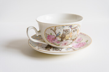 cup with saucer and owl pattern