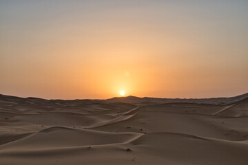 Naklejka na ściany i meble Dunes in the Sahara desert at sunrise, the desert near the town of Merzouga, a beautiful African landscape