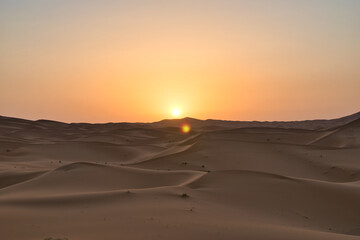 Naklejka na ściany i meble Dunes in the Sahara desert at sunrise, the desert near the town of Merzouga, a beautiful African landscape