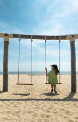 child on the swing at the beach