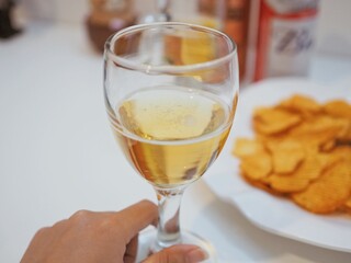 a glass of wine and snacks
