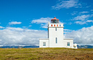 Fototapeta na wymiar Dyrhólaey Lighthouse on island of Iceland on Europe. Popular tourist sight.