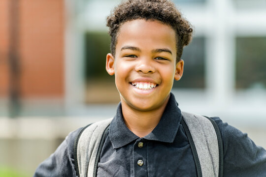Smiling african american school boy with backpack