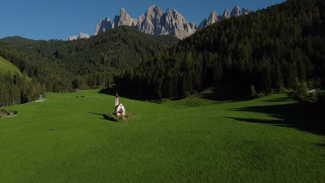 San Giovanni in Ranui St. John Church in Val di Funes Valley and Odle mountai range, Italian Dolomites. South Tyrol, Trentino Alto Adige, Italy aerial view.