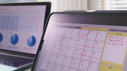 Last day of workweek white collar work remote anywhere at home office workspace on Friday. Young workforce Hybrid workplace note event to do list app on tablet plan week time timeline on table desk.