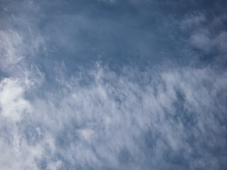 View of blue sky with white clouds in a sunny day. Background of sky with patchy clouds