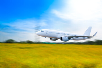 Naklejka na ściany i meble Commercial airplane above in summer season and blue sky over beautiful scenery nature background,concept business travel and transportation summer vacation travel.